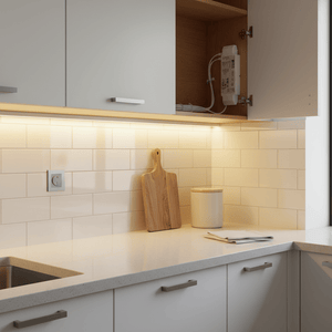 White rectangular LED power supply mounted inside open kitchen cabinet with wires
