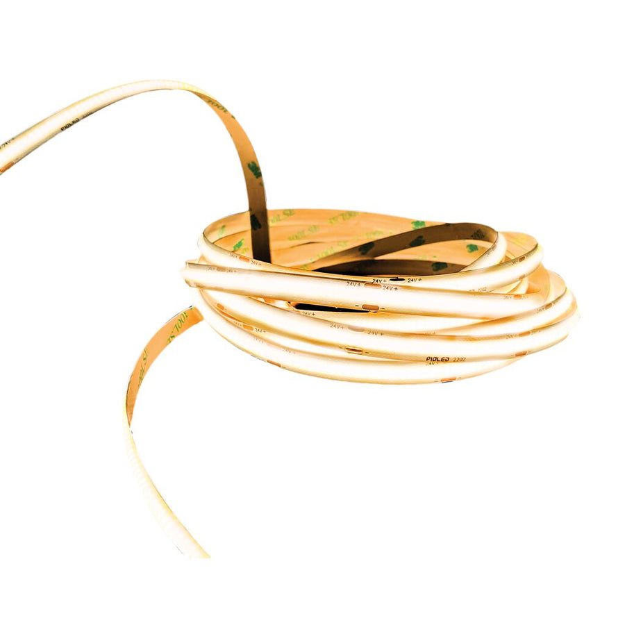 Dotless 24V COB LED Strip Light in a coiled roll, showcasing a warm white glow.