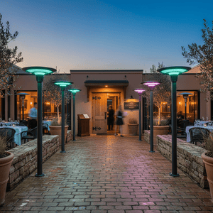 Outdoor scene featuring multiple solar post top lights with RGB colors illuminating a restaurant entrance and pathway.