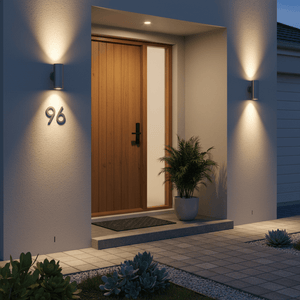 Outdoor wall light illuminating entrance with house number 96, featuring a wooden door and potted plants.