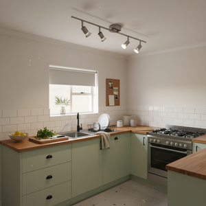Modern satin chrome ceiling spotlight bar installed in a stylish kitchen, illuminating the countertop and sink area.