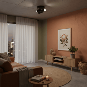 Three-light ceiling spotlight in a modern living room, illuminating a feature wall and decor.