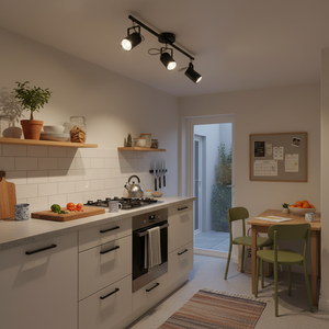 3-light black metal and polished chrome spotlight installed in a modern kitchen, illuminating worktops and dining area.