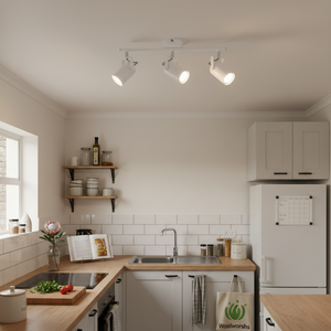 Three adjustable white ceiling spotlights illuminating a modern kitchen workspace.