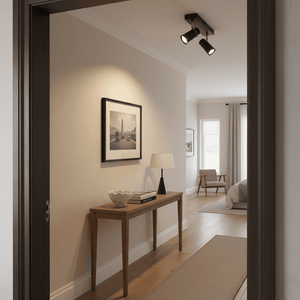 Black and gold spotlight illuminating a hallway with a wooden console table and framed artwork.