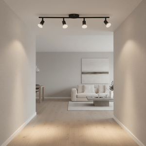 Black Buzz 4 Light Spotlight mounted on ceiling, illuminating a modern living space with a sofa and coffee table.
