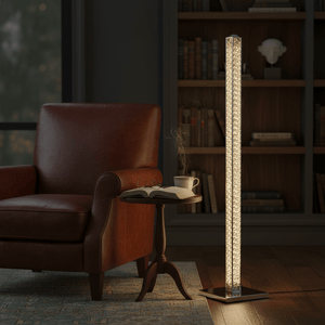 Chrome and crystal floor lamp illuminating a cozy reading nook with a leather armchair, side table, and bookshelf.