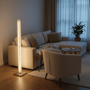 Chrome and crystal floor lamp illuminating a cozy living room with a sofa, armchair, and coffee table, creating a warm