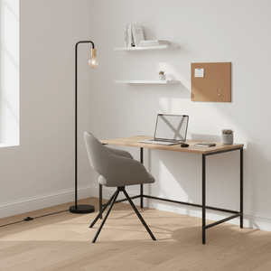Sleek black floor lamp beside a modern desk with a laptop and chair in a bright office space.