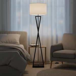 Collins Floor Lamp beside a bed and chair, featuring a fabric shade and modern design.