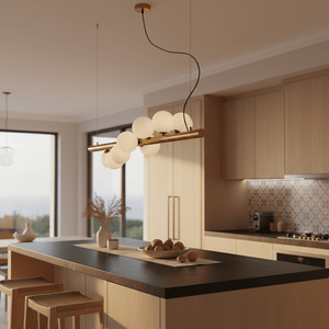 Spiral 7 Light Gold Pendant Light hanging above a kitchen island with opal glass spheres and warm gold finish.