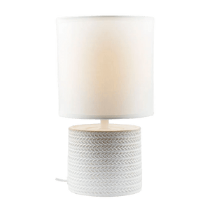 A white table lamp featuring a textured base and a cylindrical fabric shade.