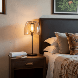 Campbell Cognac Table Lamp on a bedside table, casting a warm glow in a cozy bedroom setting.