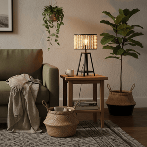 A cozy living room scene featuring a metal and wood bead table lamp on a wooden side table next to a green sofa.