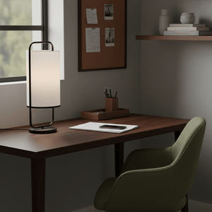 Watson Black & White Cylinder Table Lamp on a wooden desk beside a green chair, with stationery and a phone.