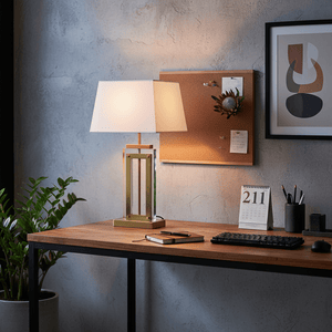 Antique brass and acrylic table lamp on a wooden desk with a calendar, notebook, and plant.