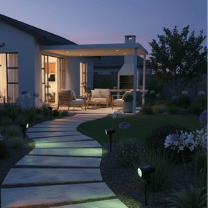 RGB solar spike lights illuminating a garden pathway at dusk, highlighting plants and outdoor seating.