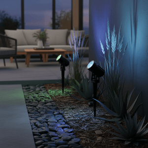 RGB solar spike lights illuminating garden plants and pathway with colorful accents at dusk.