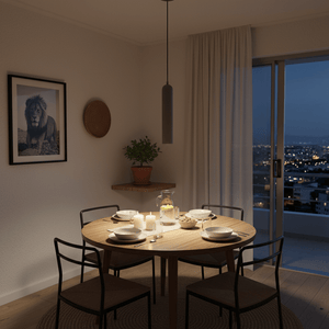 Grey pendant light illuminating a dining table set with plates and candles in a cozy indoor setting.