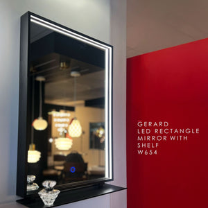 Gerard LED rectangle mirror with shelf on a wall with a red accent