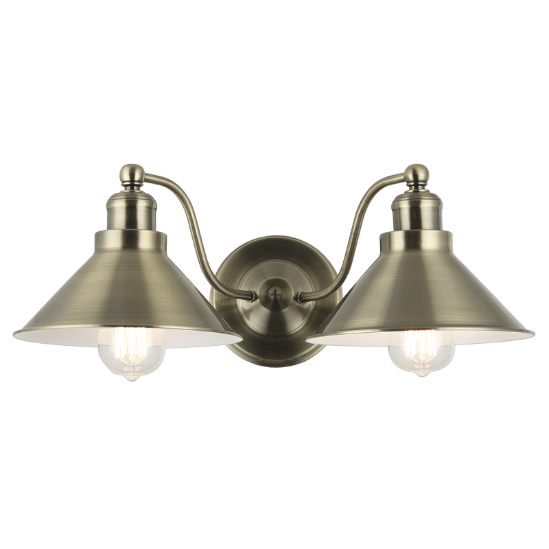 Antique brass double wall bracket with two symmetrical shades, ideal for bathroom lighting.