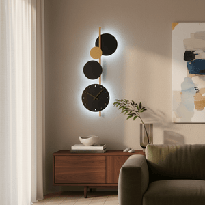 Black and gold wall light with integrated clock mounted above a wooden console table in a stylish living room.