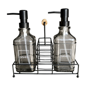 Glass soap dispenser set with smoked grey bottles and black metal caddy