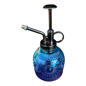 A blue and purple wash-up bottle with a metallic pump and handle, featuring a textured, decorative design.