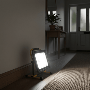 Rechargeable portable worklight illuminating a hallway, showcasing its bright LED light and sturdy design.