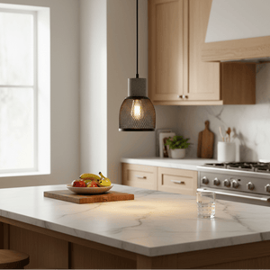 Midnight Dome Mesh & Stone Pendant Light hanging over a kitchen island with fruit bowl and glass of water.