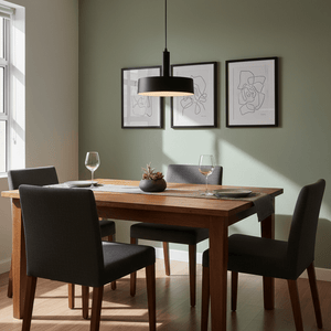Sombre Black Pendant light hanging above a wooden dining table with dark chairs and wall art.