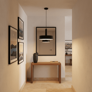 Sombre Black Pendant light hanging above a wooden console table in a stylish hallway, complemented by framed artwork.