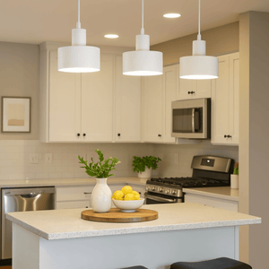 Modern kitchen with pendant lights, island, and stools.