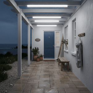 Porch area of a house with a blue door, plants, and a bench at night.