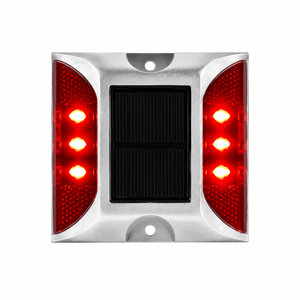 Solar road stud with red LED lights and solar panel, designed for outdoor safety and guidance.