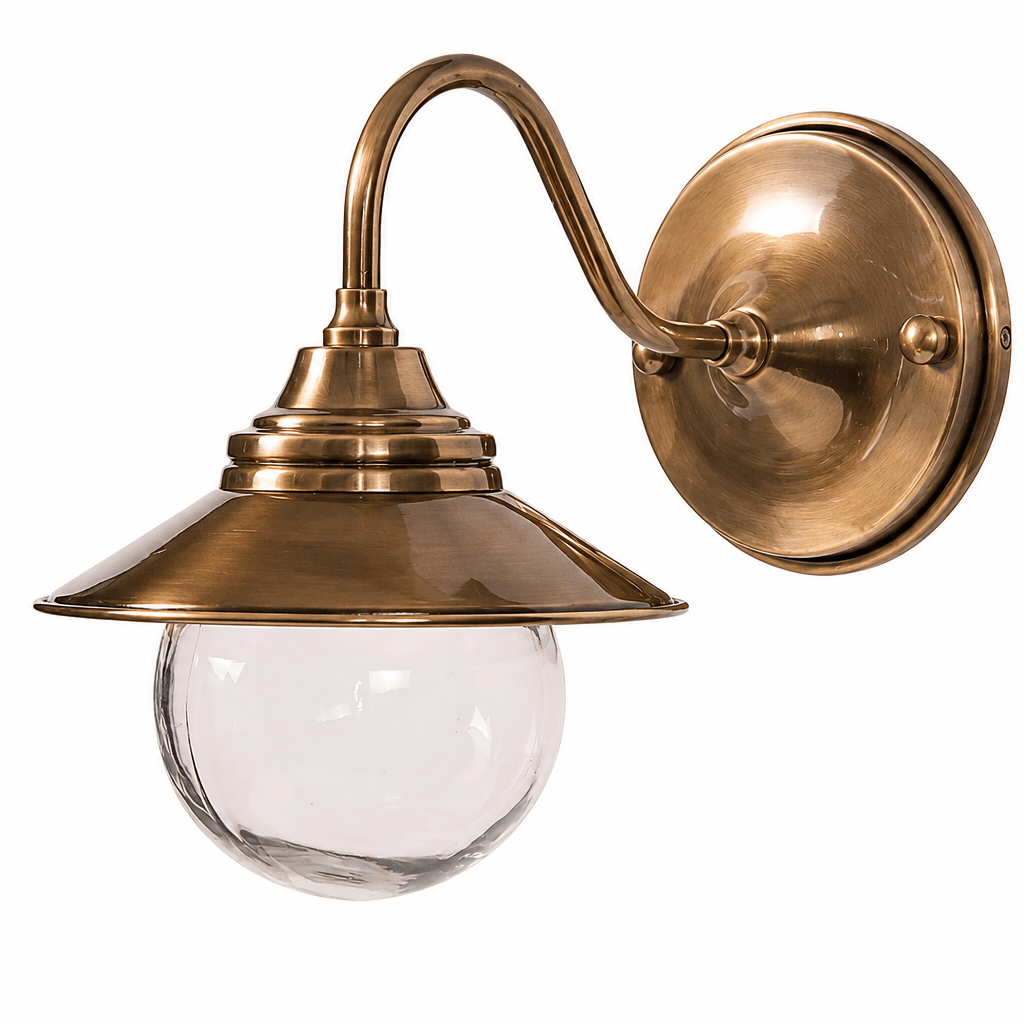 Antique brass outdoor wall lamp with a curved neck and clear glass diffuser.