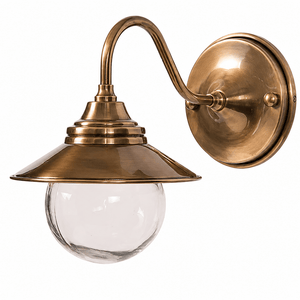 Antique brass outdoor wall lamp with a curved neck and clear glass diffuser.