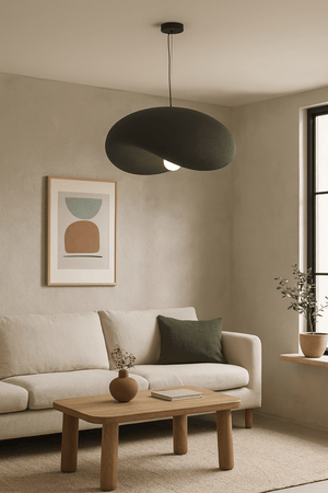 Obsidian Drift 700 Pendant Light hanging above a cozy living room with a beige sofa and wooden coffee table.