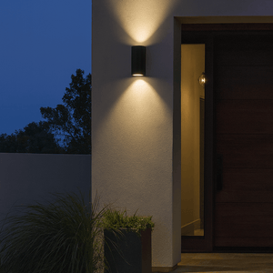 Outdoor wall light fixture on a building exterior with a dark sky background