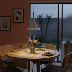 Scandinavian LED pendant light illuminating a dining table set with food and drinks, featuring a warm ambiance.