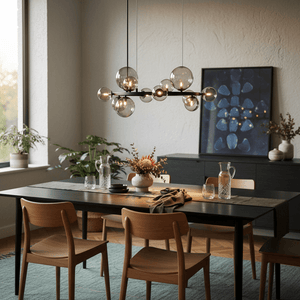 Stylish dining area featuring a Nebula Metal Pendant with smoke glass above a modern table set.
