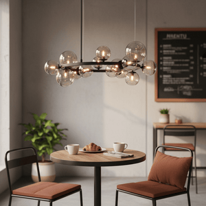 Lifestyle image of a modern pendant light above a dining table with coffee cups and a croissant.