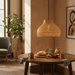 Cone Rattan Bamboo Pendant light hanging above a wooden dining table set with pottery and a loaf of bread.