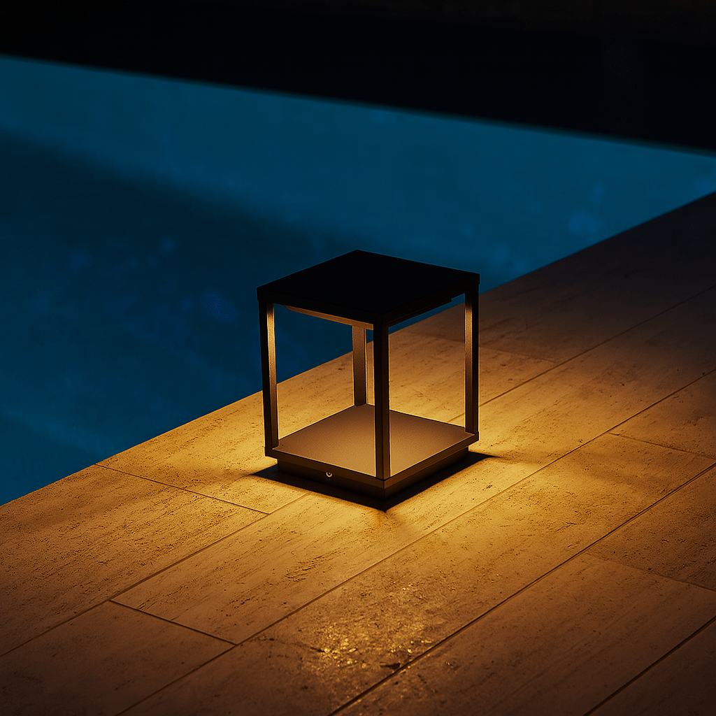 Decorative outdoor light on a stone ledge by a pool at night