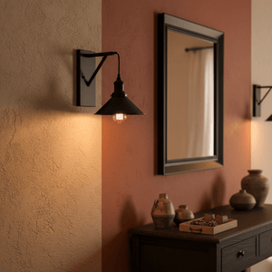Caledon Black Indoor Wall Light mounted beside a mirror, illuminating a wooden console with decorative pottery.