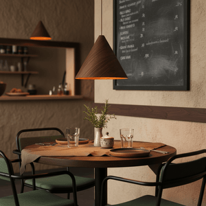 Conica Walnut Wood Veneer Pendant light hanging above a dining table set with plates and glasses.