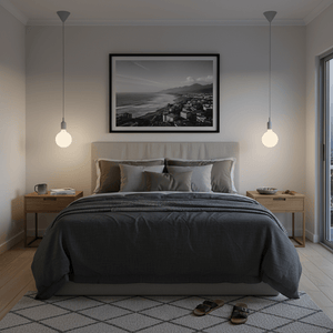 Modern bedroom with a bed, nightstands, and framed artwork on the wall.