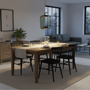 Modern green glass pendant light hanging above a wooden dining table set for a meal.