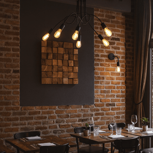 Dining area with wooden tables, chairs, and a brick wall.