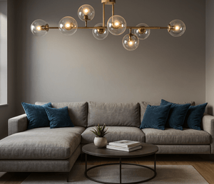 Modern living room with a gray sectional sofa, round coffee table, and decorative chandelier.